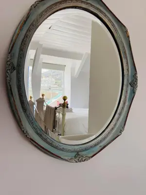 a mirror hanging on a wall in a room at Homestead in Port Isaac