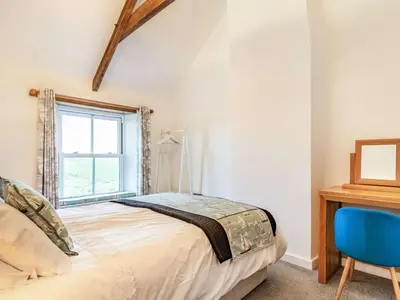a bedroom with a bed and a desk and a window at 2 Bed in Fowey oc-86873 in Saint Veep