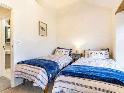 two beds in a room with white walls at 2 Bed in Fowey oc-86873 in Saint Veep