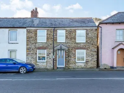a blue car parked in front of a brick house at 2 Bed in Fowey oc-86873 in Saint Veep