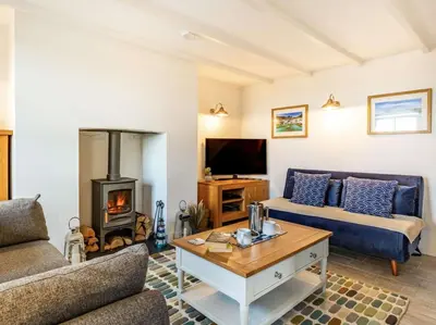 a living room with a couch and a fireplace at 2 Bed in Fowey oc-86873 in Saint Veep