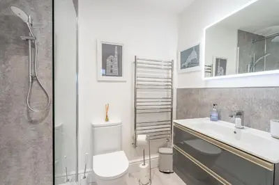 a bathroom with a toilet and a sink and a shower at Porthleven B and B in Helston