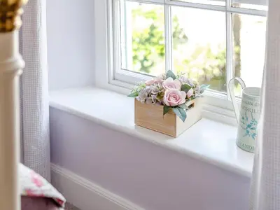 a wooden box with flowers sitting on a window sill at 3 Bed in Polruan oc-pc012 in Polruan