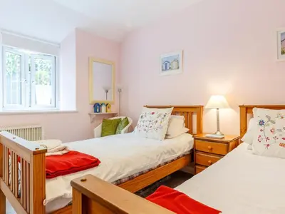 a bedroom with two twin beds and a window at 3 Bed in Polruan oc-pc012 in Polruan