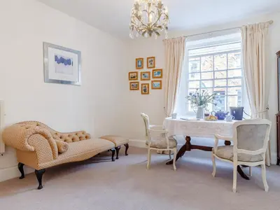 a dining room with a table and chairs and a chandelier at 3 Bed in Polruan oc-pc012 in Polruan