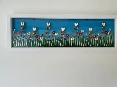 a painting of a field of flowers with bees at BumbleBee Lodge in Saint Cleer