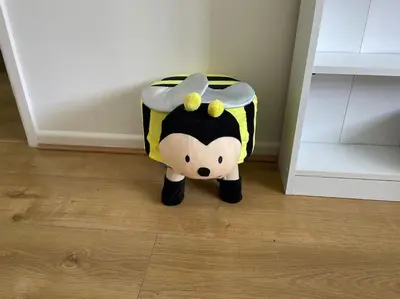 a toy cow is sitting on the floor at BumbleBee Lodge in Saint Cleer