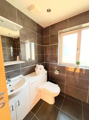 a bathroom with a toilet and a sink at Caledonian House - Newquay in Newquay