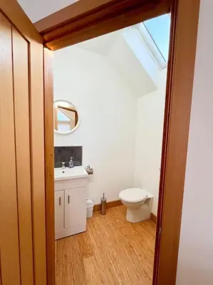 a bathroom with a toilet and a sink at Caledonian House - Newquay in Newquay