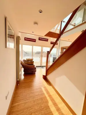 a hallway with a staircase in a house at Caledonian House - Newquay in Newquay