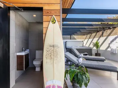 a surfboard in a bathroom with a toilet and stairs at 3 Bed in South Tehidy oc-90549 in Camborne