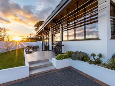 an exterior view of a house with a sunset at 3 Bed in South Tehidy oc-90549 in Camborne