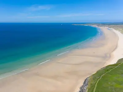 an aerial view of a beach with the ocean at 3 Bed in South Tehidy oc-90549 in Camborne