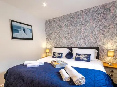 a bedroom with a blue bed with a blue blanket at 4 Bed in Helston oc-90391 in Crowan