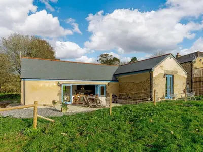 a stone house with a patio in a yard at 4 Bed in Helston oc-90391 in Crowan