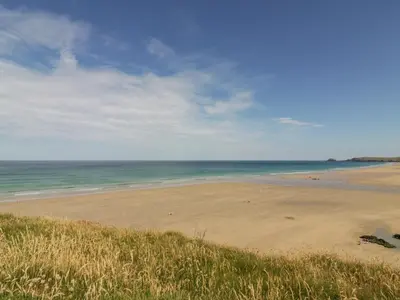 a sandy beach with the ocean in the background at Lapwing in Perranporth