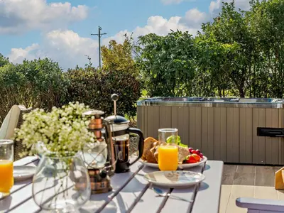 a table with a plate of food and orange juice at 1 Bed in Camelford oc-90818 in Camelford