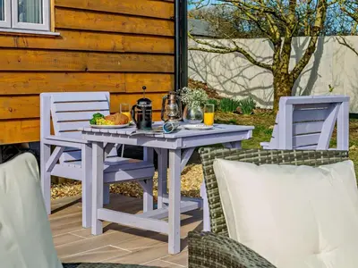 a white table and chairs on a patio at 1 Bed in Camelford oc-90818 in Camelford