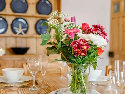 a vase filled with flowers sitting on a table at 2 Bed in Fowey oc-91396 in Fowey