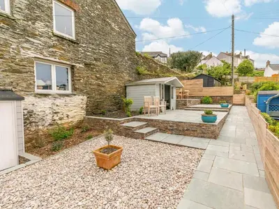 a stone house with a garden and a patio at 2 Bed in Fowey oc-91396 in Fowey