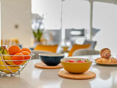 a table with bowls of fruit and bread on it at 4 Bed in Fowey oc-91931 in Fowey