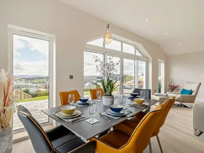 a dining room with a table and chairs at 4 Bed in Fowey oc-91931 in Fowey