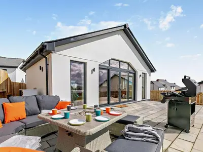 a living room with a couch and a table on a patio at 4 Bed in Fowey oc-91931 in Fowey