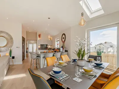 a dining room and living room with a table and chairs at 4 Bed in Fowey oc-91931 in Fowey