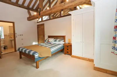 a bedroom with a bed and a wooden ceiling at Beachside holiday home in St Merryn