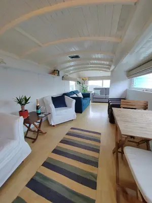 a living room with white furniture and a rug at Unique coastal detached property in Truro