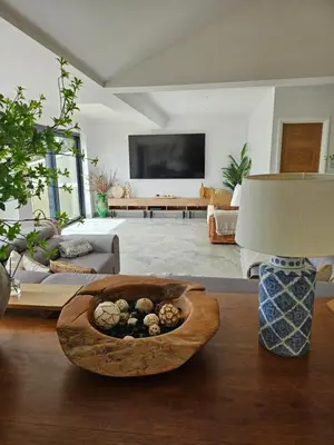 a living room with a bowl of rocks on a table at Stunning Front Line Ocean Views Luxury Beach House in Downderry