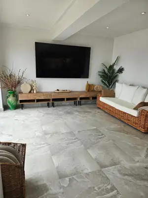 a living room with a couch and a flat screen tv at Stunning Front Line Ocean Views Luxury Beach House in Downderry