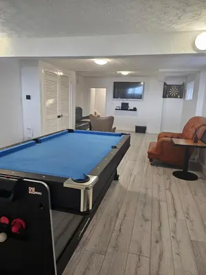 a living room with a pool table in it at Stunning Front Line Ocean Views Luxury Beach House in Downderry