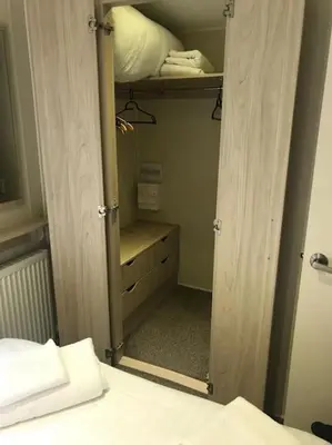 a bedroom with a closet with a mirror and a bed at 2 Bedroom Caravan. Newquay. Cornwall. in Newquay