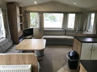 a living room with a couch and a table at 2 Bedroom Caravan. Newquay. Cornwall. in Newquay
