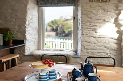 a table with a plate of food on top of it at White House, Port Isaac Bay Holidays in Port Isaac