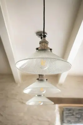 a large white light hanging from a ceiling at White House, Port Isaac Bay Holidays in Port Isaac