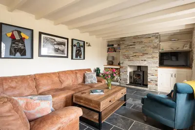 a living room with a couch and a fireplace at White House, Port Isaac Bay Holidays in Port Isaac