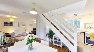 a living room with a staircase and a living room at 45 Trevithick Court, Tolroy Manor in Hayle