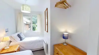 a small room with a bed and a window at 46 Strawberry Hill, Tolroy Manor in Hayle