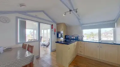 a kitchen with a counter top and a large window at G23 Norda, Riviere Towans in Hayle