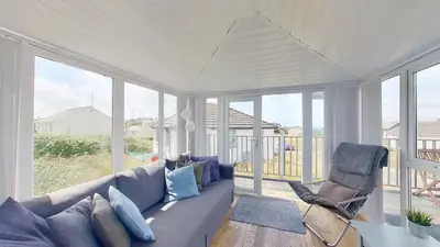 a living room with a couch and a chair at G23 Norda, Riviere Towans in Hayle