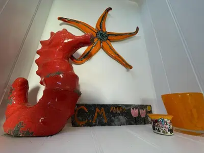 a red anchor hanging on a wall next to a sign at Cilia Marys Annexe St Teath in Saint Teath