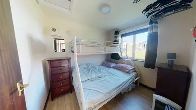 a small bedroom with a bunk bed and a dresser at D53 Bide A Wee, Riviere Towans in Hayle