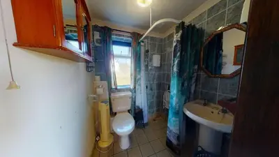 a small bathroom with a toilet and a sink at D53 Bide A Wee, Riviere Towans in Hayle