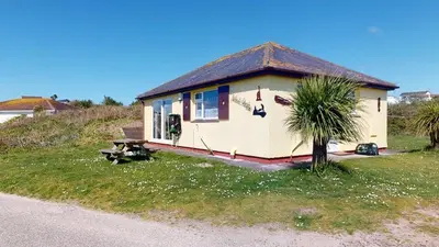 a small house on the side of a hill at D54 Wheal Shoat, Riviere Towans in Hayle