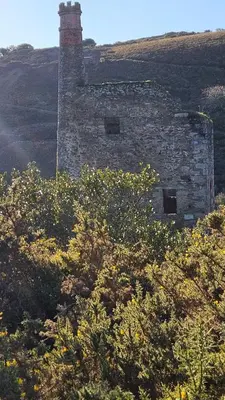 an old brick building sitting on top of a hill at Driftwood in Porthtowan