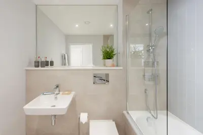 a bathroom with a sink toilet and a shower at Oceans Eleven - Sea view - Secure parking - Footsteps from beach in Falmouth