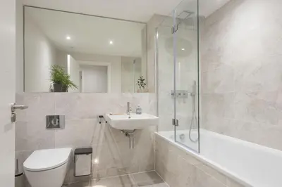 a bathroom with a toilet and a sink and a shower at Harlyn Penthouse, Harlyn Bay - 1 pet accepted - Free Wi-fi - Sea View in St Merryn