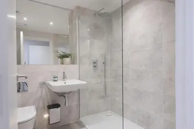 a bathroom with a shower and a sink and a toilet at Harlyn Penthouse, Harlyn Bay - 1 pet accepted - Free Wi-fi - Sea View in St Merryn